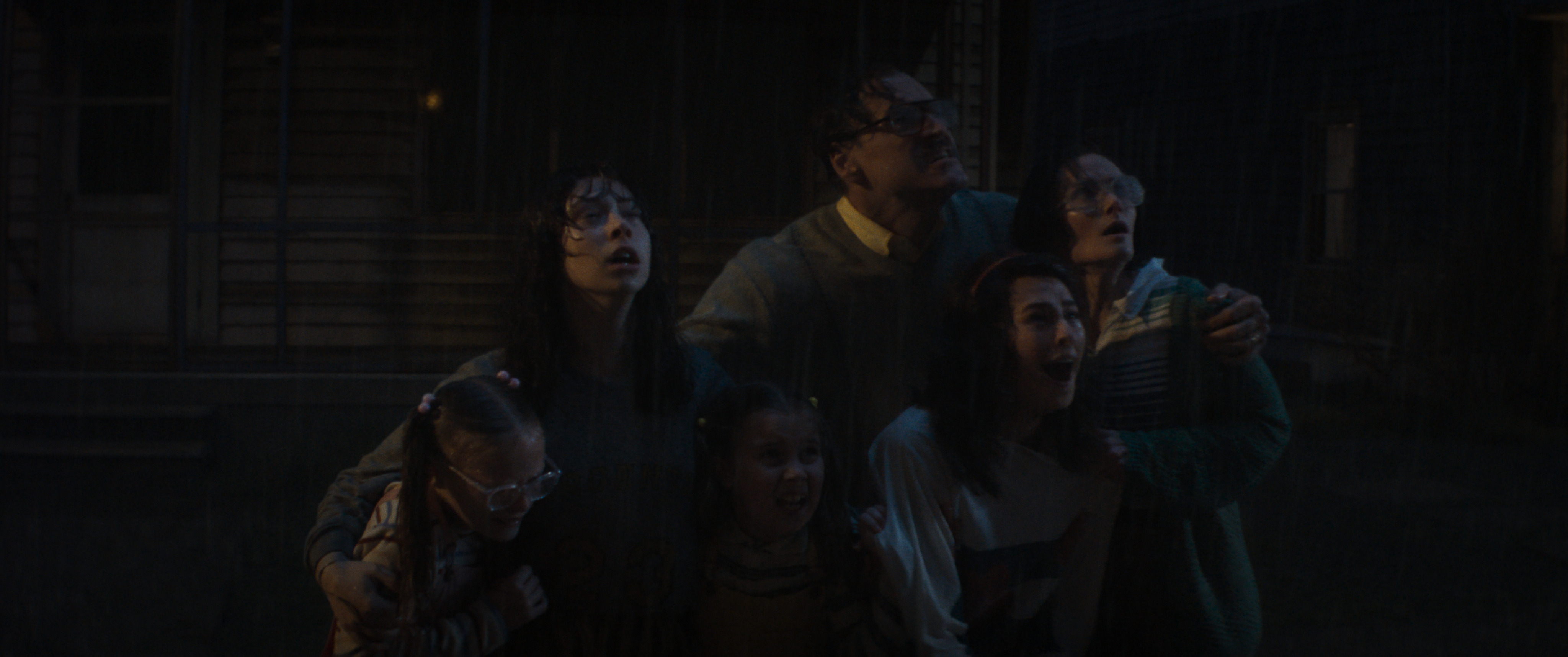 (L-R): TILLY WALKER as Carin Smurl, KILA LORD CASSIDY as Heather Smurl, MOLLY CARTWRIGHT as Shannon Smurl, ELLIOT COWAN as Jack Smurl, BEAU GADSON as Dawn Smurl, and REBECCA CALDER as Janet Smurl in New Line Cinema’s “CONJURING: LAST RITES,” a Warner Bros. Pictures release